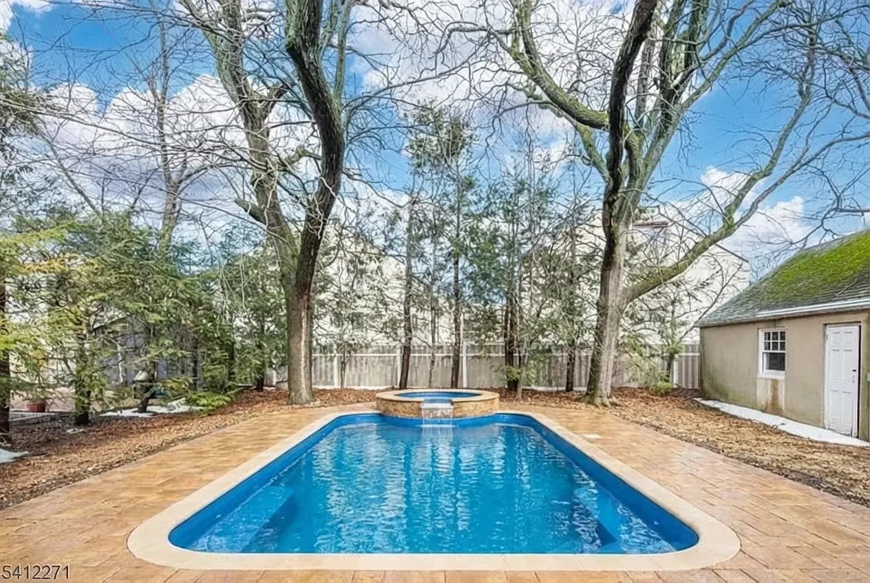 Design 3 — fiberglass pool, paver deck, raised spa with spillover, all trees preserved, designed by Seasonal World